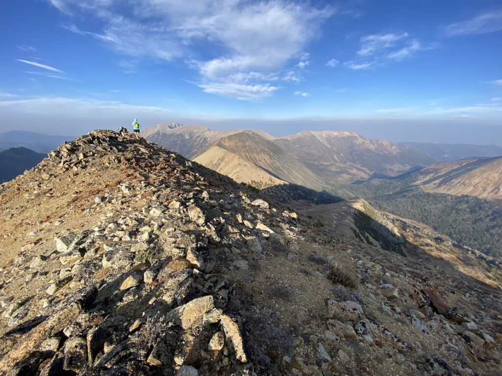 solo woman hiker on peak in Montana